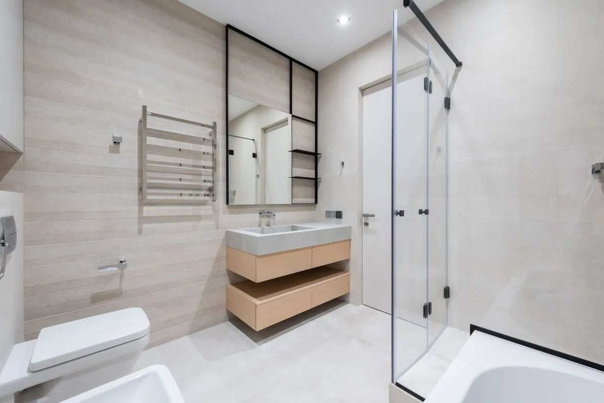 Bathroom with a glass shower and a wood vanity