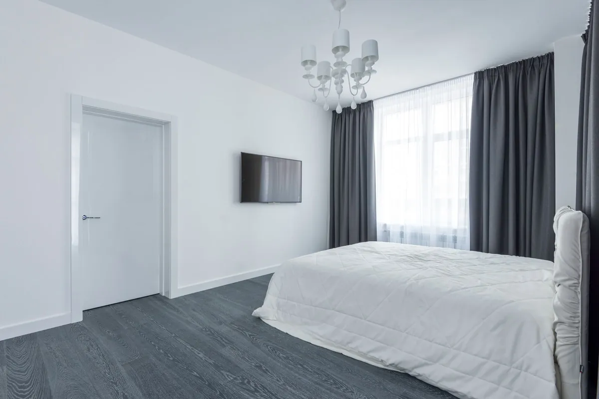 White bedroom with gray curtains