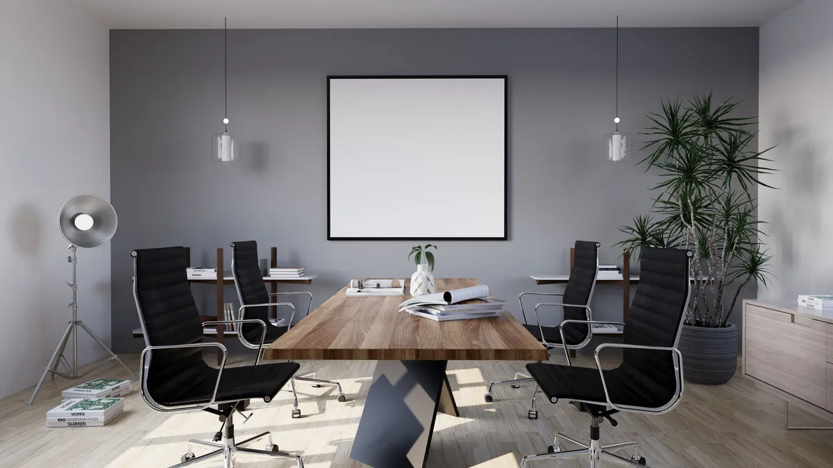 Conference room with a long wood table and black chairs