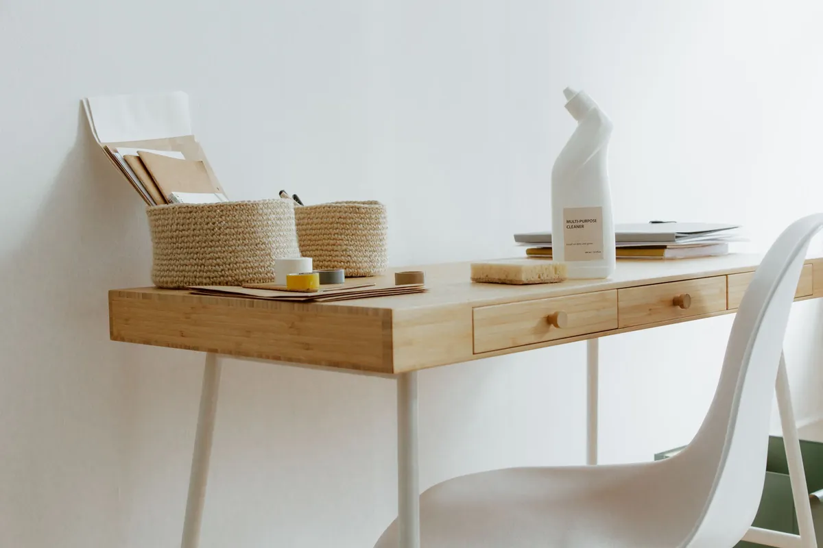 Desk with cleaning products and storage baskets