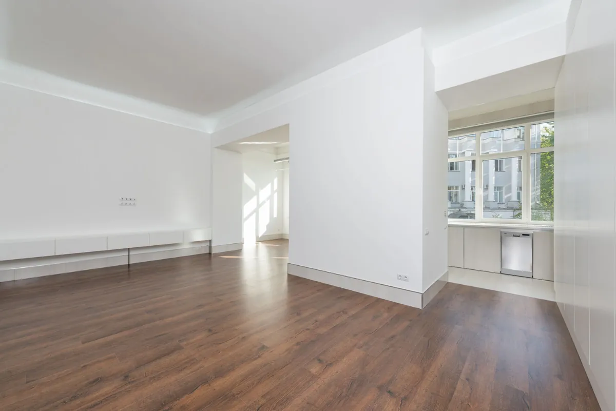 Empty room with wood floors and white walls