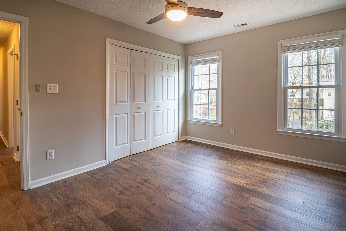 Empty bedroom with a ceiling fan and hardwood floors