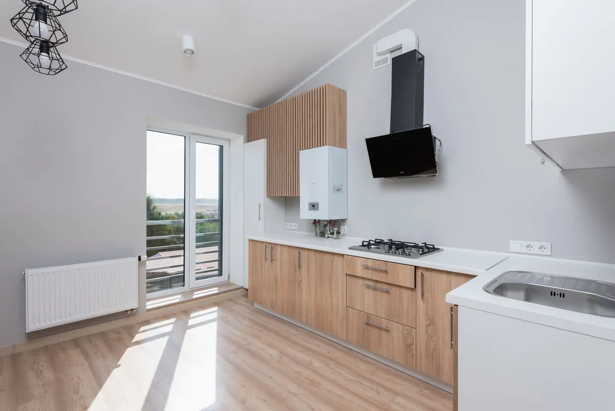 Sunny kitchen with wood cabinets and a balcony door