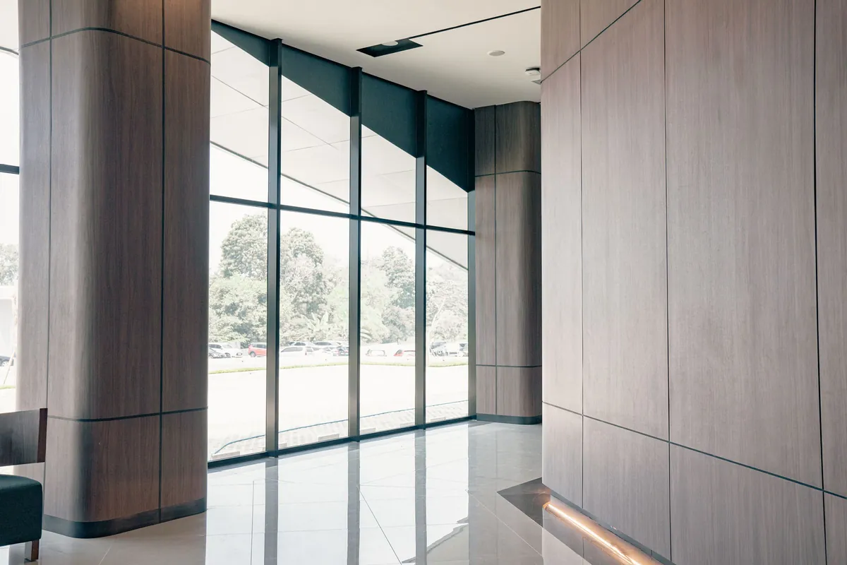 Glass-walled corridor with a polished tile floor