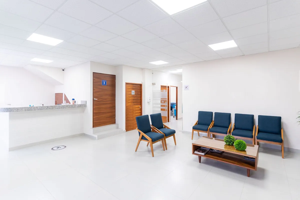 White clinic waiting room with navy chairs